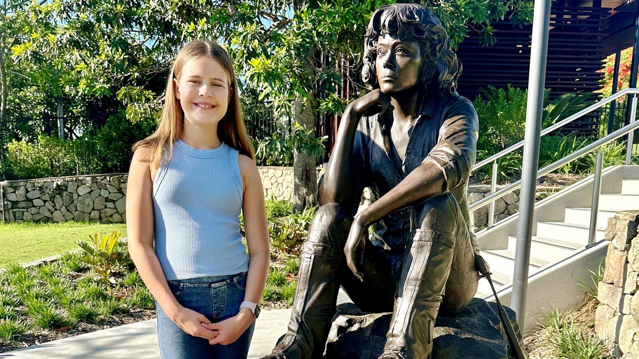 Malia Knox with the new bronze statue of Dr Abigail Allwood in Brisbane Botanic Gardens.