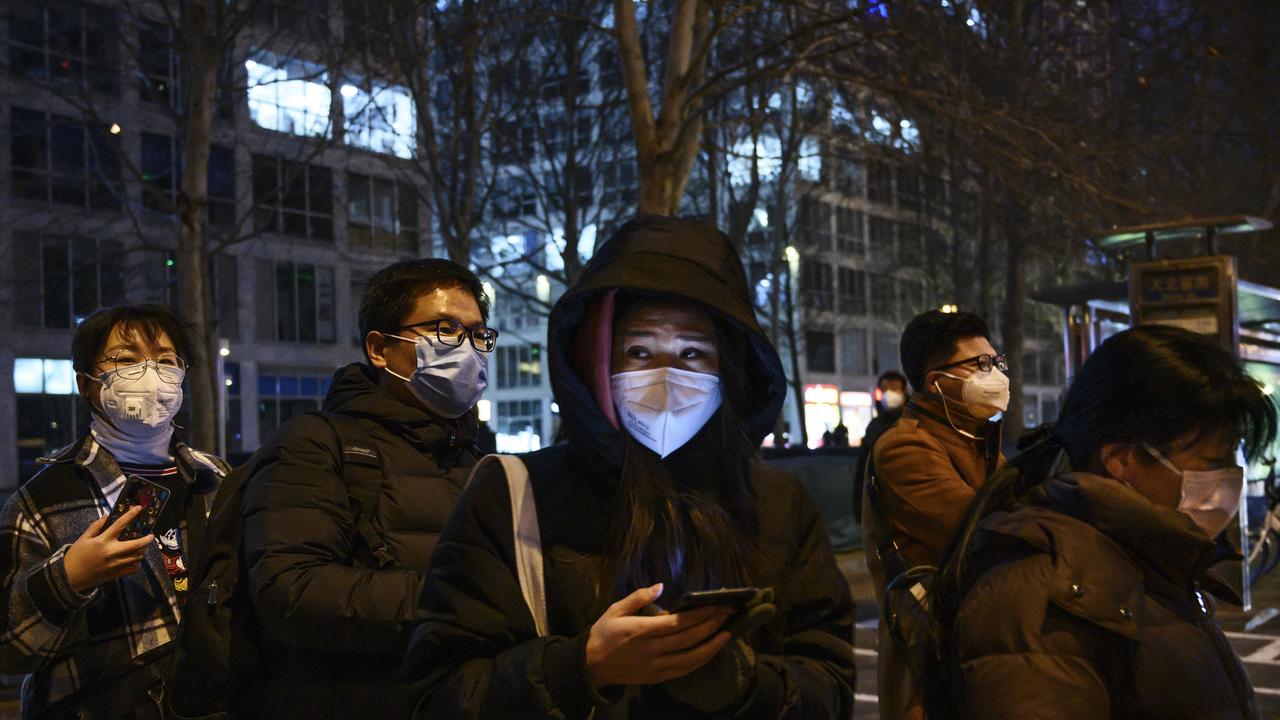 Workers in Beijing waiting to take the bus. Picture: Kevin Frayer/Getty Images