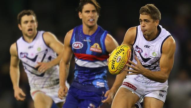 Stephen Hill runs away from Ryan Griffen at Etihad Stadium.