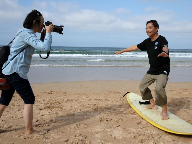 Mr Yan can’t resist a surfboard pose. Picture: Toby Zerna