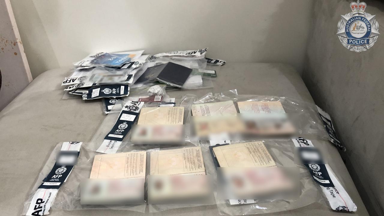 Fake passports, international driver‘s licences and luxury handbags were allegedly seized. Picture: Australian Federal Police.