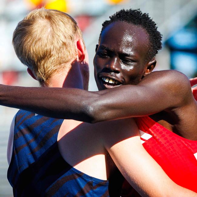 Australia's Gout Gout (R) celebrates with a competitor.