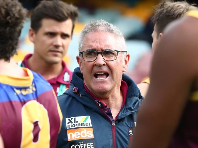 BRISBANE, AUSTRALIA - JUNE 28: Lions coach Chris Fagan talks to his team during the round 4 AFL match between the Brisbane Lions and the Adelaide Crows at The Gabba on June 28, 2020 in Brisbane, Australia. (Photo by Jono Searle/AFL Photos/via Getty Images )