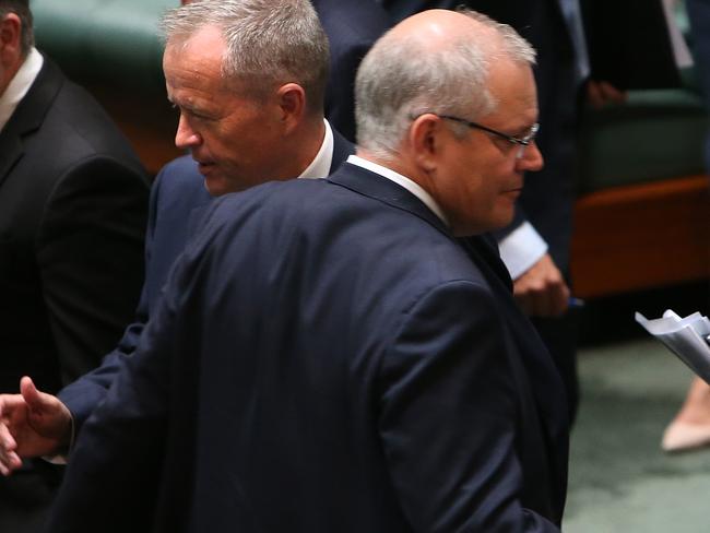 PM Scott Morrison and Opposition Leader Bill Shorten cross paths during a division in the House of Representatives Chamber yesterday. Picture: Kym Smith