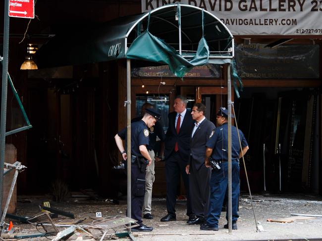 New York Mayor Bill de Blasio (third right) and New York Governor Andrew Cuomo (second right) tour the site of the explosion. Picture: AFP/Justin Lane