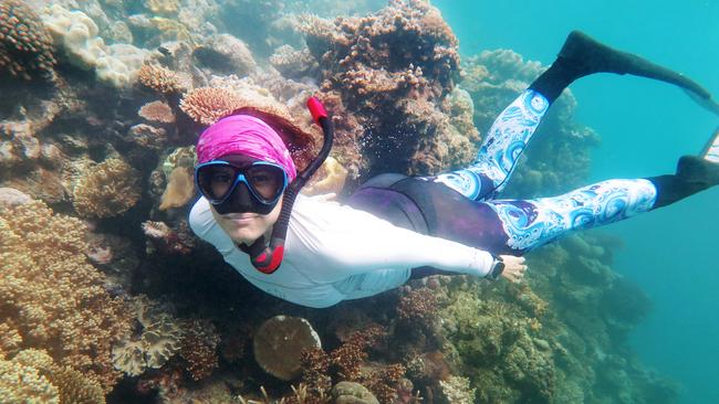 Tanya Murphy snorkels over coral on Moore Reef, one of 150 local heroes who attended a music concert on the Reef Magic pontoon as part of Savannah Sounds on the Reef, the first ever concert to be held on the northern Great Barrier Reef. Picture: Brendan Radke