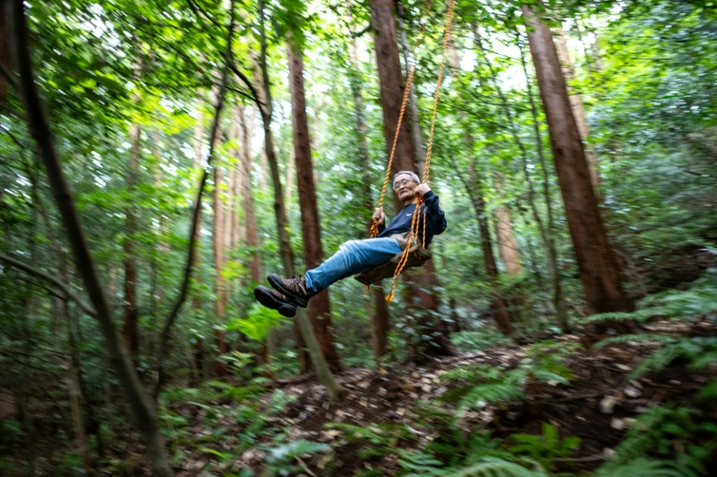 'Poop master' Masana Izawa, seen playing on a swing, says giving facese back to nature is a 'sublime act'