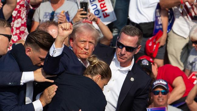 Trump said he raised his hand in the air following the shooting to let the crowd know he was OK. (Photo by Rebecca DROKE / AFP)