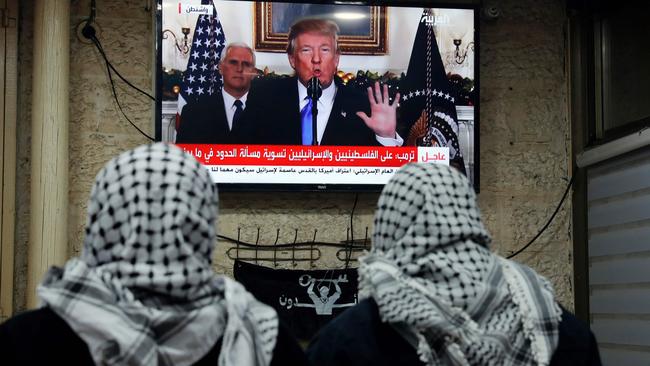 Palestinian men watching an address given by US President Donald Trump at a cafe in Jerusalem. Picture: Ahmad Gharabli