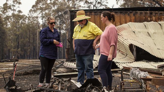 Anthony Hayter and his daughters inspecting the damage to his property off Silverdale Rd, Orangeville on Thursday. Picture: Adam Yip