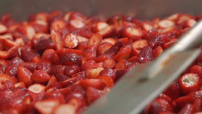 Qantas staff cutting a tonne of strawberries