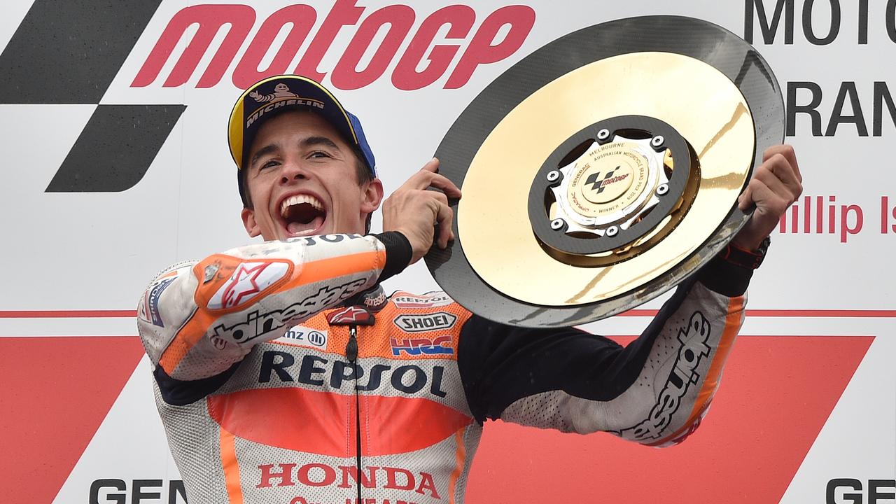 Marc Marquez holds up the trophy after winning the Australian Grand Prix. Picture: Peter Parks