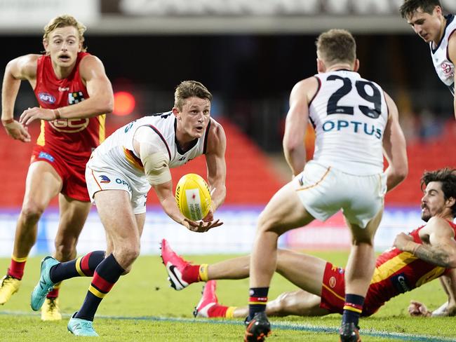 Matt Crouch of the Crows handballs during the Round 3 AFL match between the Gold Coast Suns at Metricon Stadium. Picture: AAP IMAGE/DAVE HUNT