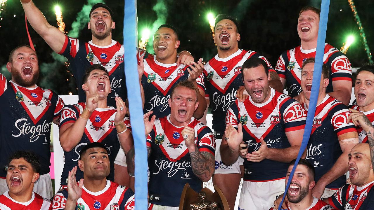 Roosters players sing the team song on the podium. Picture. Phil Hillyard