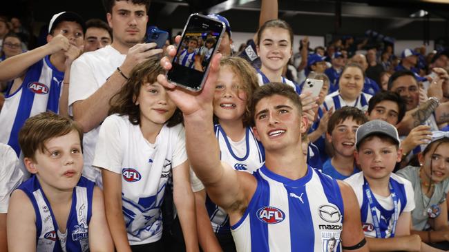 Harry Sheezel of the Kangaroos celebrates with fans after winning the round 1 AFL match between North Melbourne and West Coast.