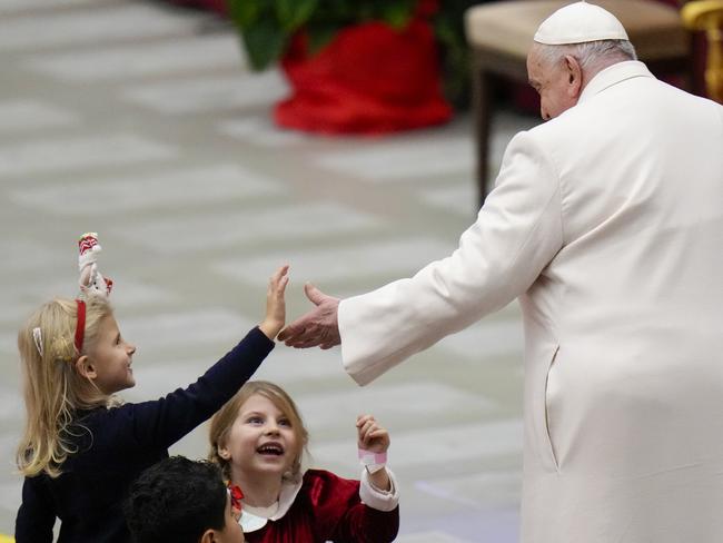 Pope Francis is greeted by children as he celebrates his birthday in December 2023. Picture: AP