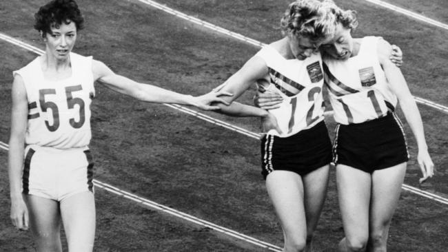 Ann Packer (left) silver medallist, acknowledges defeat at the hands of Betty Cuthbert (centre), winner of the 400 metres at the Tokyo Olympic Games. Bronze medallist Judith Amooreis on the right.