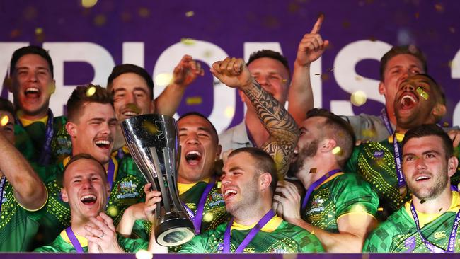 Wade Graham and Daly Cherry-Evans of Australia lift the trophy with team mates after victory in the Men's Rugby League World Cup 9s Final over New Zealand during the Downer Rugby League World Cup 9's competition at Bankwest Stadium in Sydney, Saturday, October 19, 2019. (AAP Image/Brendon Thorne) NO ARCHIVING, EDITORIAL USE ONLY