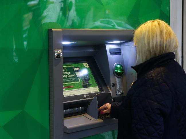 SYDNEY, AUSTRALIA - NewsWire Photos -FEBRUARY 22 2022: Pedestrians are seen walking past an ATM machine in Sydney. Picture: NCA Newswire / Gaye Gerard