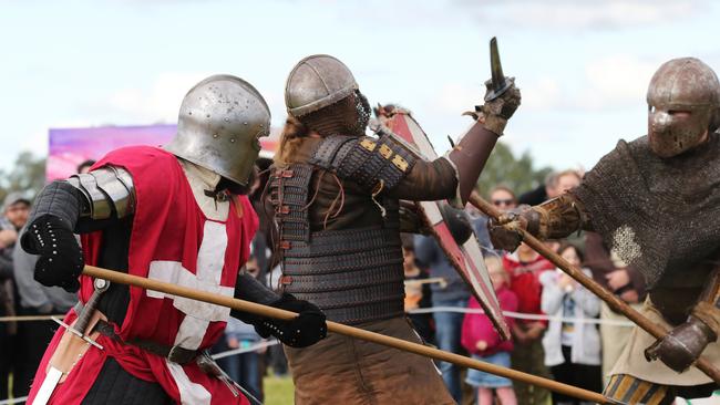 Men battle it out with a sword fight at the Hawkesbury Showground Winterfest Medieval Festival on Saturday, July 7, 2018. The festival drew a large crowd from the Hawkesbury area who came for the food, folk music and fun. (AAP Image/David Swift)