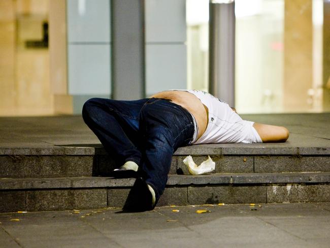 12/12/2009 NEWS: A drunk man passed out on steps in Castlereagh Street, Sydney city, as police put Operation Unite into effect, reclaiming the street from drunks, drug use and violence.