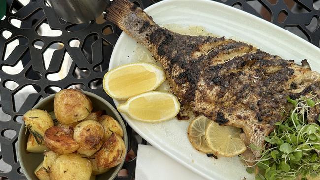 The barbecue whole snapper with two sides, potatoes roasted in duck fat and a caprese salad. Picture: Letea Cavander