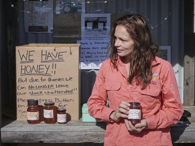 Tammy Gardner stands with her Raw Bee Co roadside stall that has been getting robbed over the past three weeks. Photo: Adam Hourigan