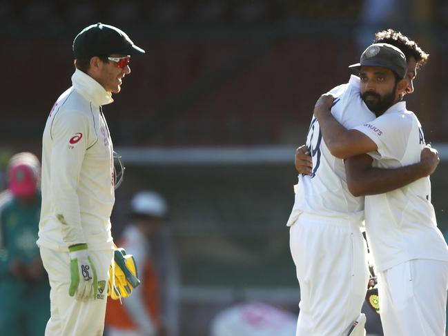 SYDNEY, AUSTRALIA - JANUARY 11: Tim Paine of Australia watches on as Ravichandran Ashwin of India embraces his captain Ajinkya Rahane of India as they celebrate securing a draw during day five of the Third Test match in the series between Australia and India at Sydney Cricket Ground on January 11, 2021 in Sydney, Australia. (Photo by Mark Kolbe/Getty Images)