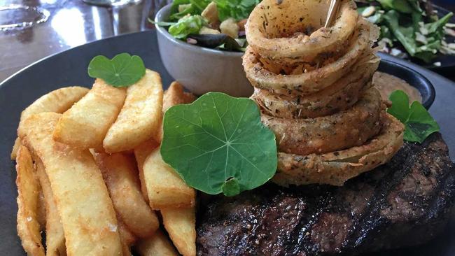 MR JONES AND ME: New menu item, 300gm Wagyu with chips salad and onion rings. Picture: Caitlin Zerafa