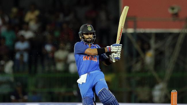 India's captain Virat Kohli plays a shot on his way to bringing up his 30th ODI century.