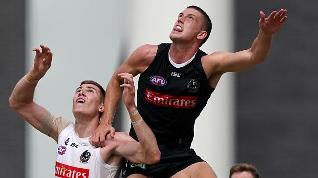 Darcy Cameron leaps above Mason Cox at training (just a reminder that Cox stands over two metres tall …). Picture: AAP Image/Sean Garnsworthy