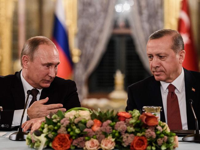 (FILES) This file photo taken on October 10, 2016 shows Russian President Vladimir Putin (L) speaking to Turkish President Recep Tayyip Erdogan (R) as they attend a press conference in Istanbul. Veteran diplomat Andrei Karlov was shot nine times in the back by an off-duty Turkish policeman at the opening of an exhibition of Russian photography on December 19, 2016. Erdogan said in a speech in Istanbul that he and Putin agreed in a phone call after the murder that 
