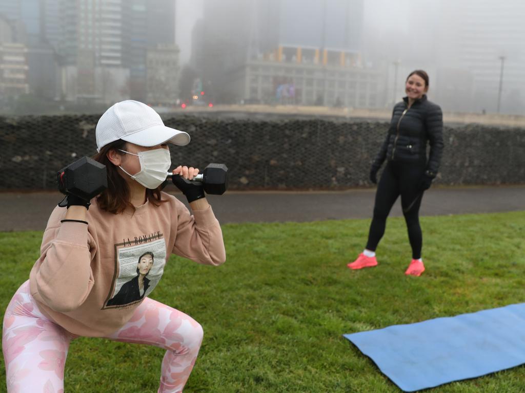 People exercise in Birrarung Marr park in Melbourne. Picture: David Crosling