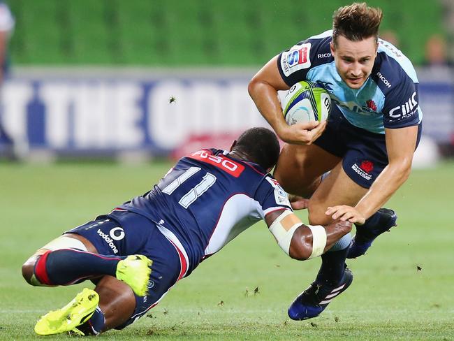 Marika Koroibete of the Rebels tackles David Horowitz of the Waratahs.