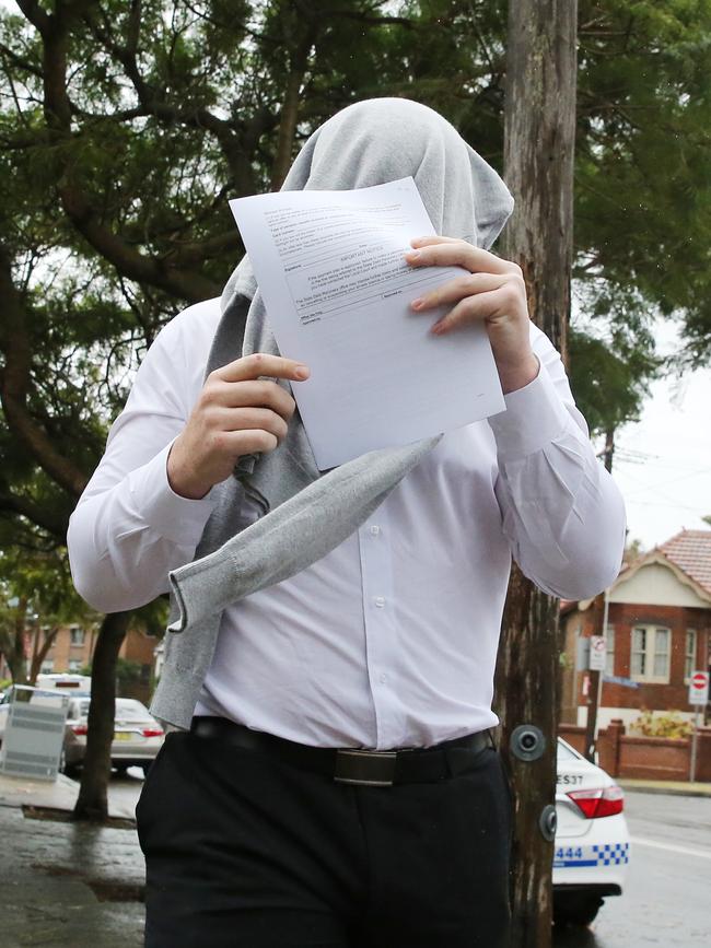 Michael Koheleti Morgan, 24, covered his face as he entered court today. Picture: Richard Dobson