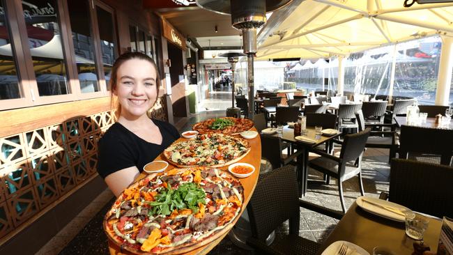 Pictured is waitress Monique Geoghegan (21) from Bondi Pizza outside showing Church street with a pizza in her hands. Also generic street scenes of eateries. Parramatta.