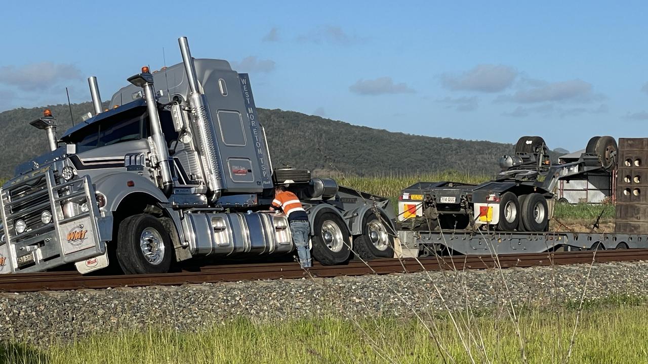 Semi-trailer lands on train line after Bruce Hwy crash