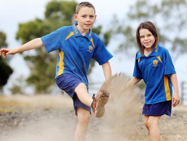 Mason, 8, and Indee Russell, 6, demonstrate how dry and dusty it is at Valkyrie State School. Picture: Tara Croser