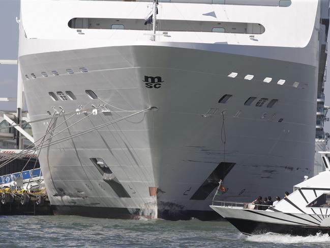 A small boat passes by the MSC Opera cruise ship moored at the Venice harbour, Italy. Picture: AP