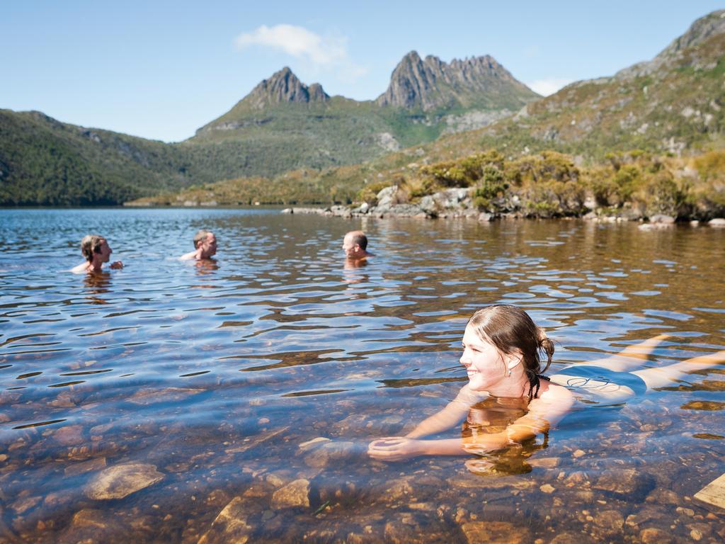 <b>CRADLE MOUNTAIN, TASMANIA:</b> Hold on a minute, you can’t swim a mountain, can you? Actually, you can. If you’ve work up a sweat on a hike around Dove Love, you could take the plunge and admire striking views of the mountain, near the start of the epic Overland Track. But for a truly exhilarating option, a canyoning tour will see you don a wetsuit and climb, jump, abseil and swim through some of Tassie’s otherwise inaccessible wilderness highlights. Canyoning does require a certain amount of courage, but there are options that cater to kids from age eight. <a href="http://www.cradlemountaincanyons.com.au/" target="_blank">cradlemountaincanyons.com.au</a>, <a href="http://www.cradlehuts.com.au/" target="_blank">cradlehuts.com.au</a> Picture: Tim Hughes / Tourism Tasmania