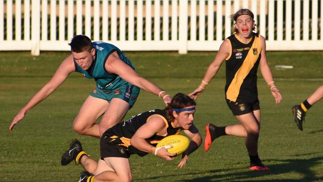 Grafton's Clancy O'Neill manages to avoid a tackle from Nicklaus Stanlan-Velt of the Coffs Breakers. Photo: Green Shoots Marketing.