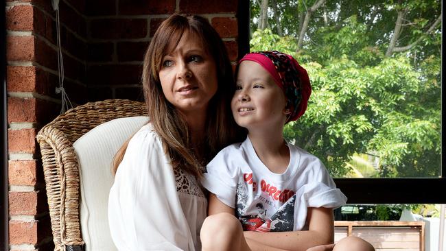 Terminally ill eight-year-old Charlie Carr with mum Melissa at home in Whitebridge, Newcastle ... her one big wish is to meet Boy Band One Direction. Picture by Peter Lorimer.