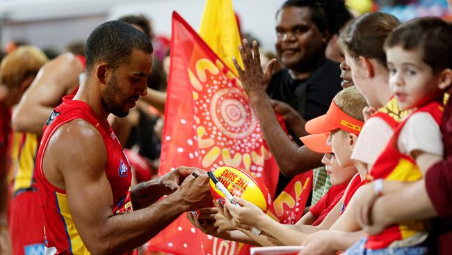 Touk Miller of the Suns signs a footy after the 2024 AFL Round 09 match between the Gold Coast SUNS and North Melbourne Kangaroos at TIO Stadium on May 11, 2024 in Darwin, Australia. Picture: Dylan Burns/AFL Photos via Getty Images