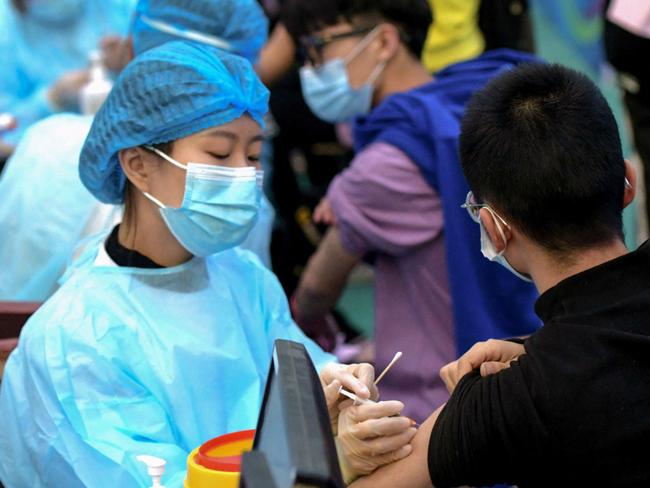 A medical worker administers a dose of the Sinovac vaccine at a university in Qingdao in China's eastern Shandong province. Picture: AFP