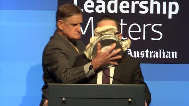 Qantas CEO Alan Joyce has the pie pushed onto his face at the Hyatt Regency hotel in Perth.
