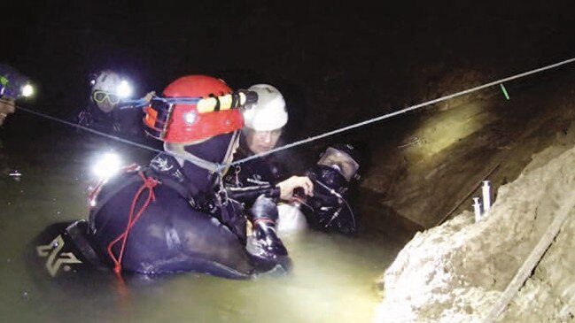 One of the Thai cave boys with his full mask on supported by members of the cave diving team including Chris Jewell, Rick Stanton and John Volanthen. Picture: Richard Harris.