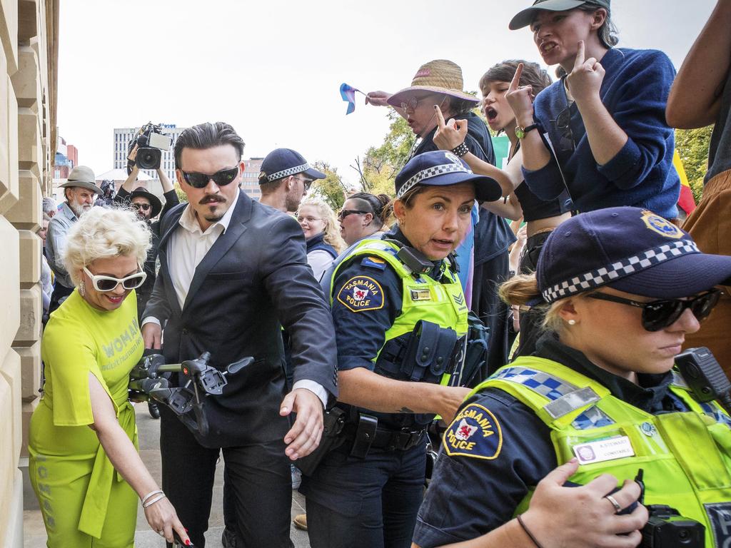 Anti-trans activist Kellie-Jay Keen leaves the Tasmanian Parliament grounds as Equality Tasmania and LGBTQI+ supporters counter-protest at the Let Women Speak rally. Picture: Chris Kidd
