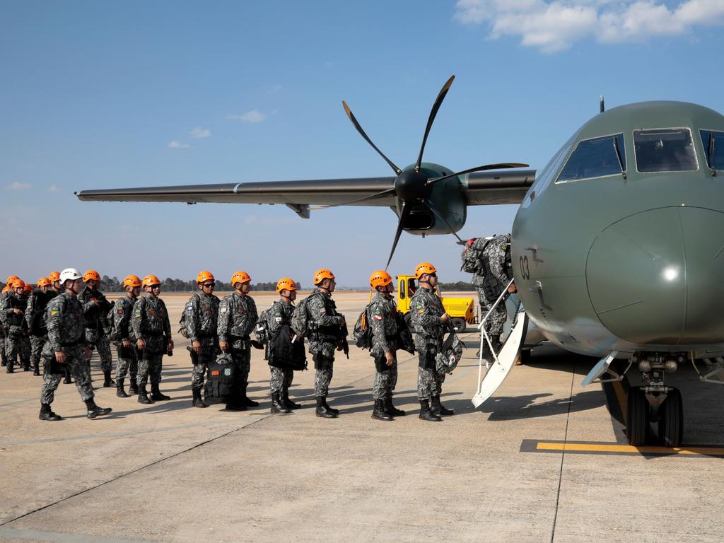 National Force military firefighters stand in line to board a plane to Rondonia northern Brazil, to help fight fires in the Amazon rainforest. Picture: Sérgio Lima/AFP