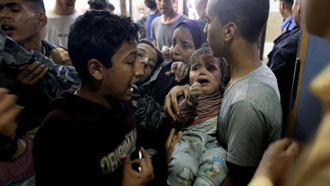 A wounded Palestinian child and other members of the Baraka family arrive at Nasser Hospital in Khan Yunis, following Israeli air strikes that hit their building in the southern Gaza Strip city. Picture: AFP