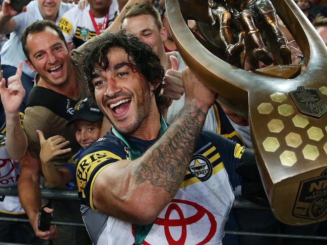 Cowboy's Johnathan Thurston holds the trophy in front of Cowboys fans after the 2015 NRL Grand Final between the Brisbane Broncos and North Queensland Cowboys at ANZ Stadium, Sydney. Pic Brett Costello